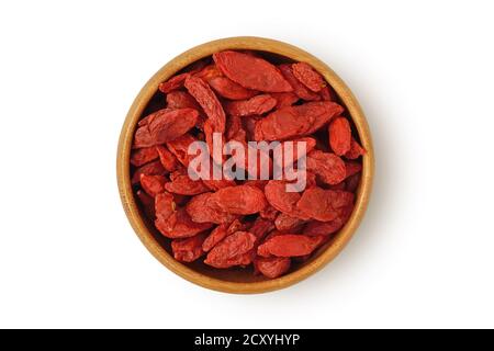 Dried goji berries in wooden bowl on white background Stock Photo