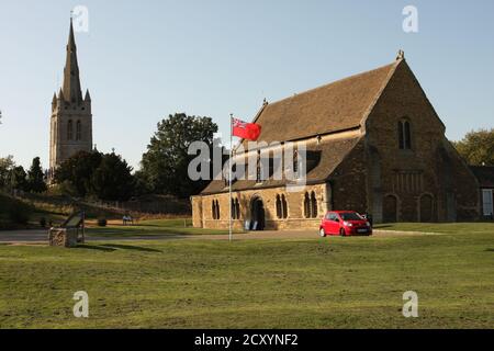 Great Hall of Oakham Castle (outside) with All Saints church in background Stock Photo