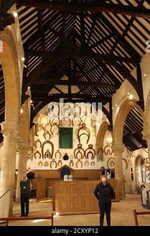Great Hall of Oakham Castle (inside) showing the horseshoes given by Peers of the Realm, pillars and beams Stock Photo