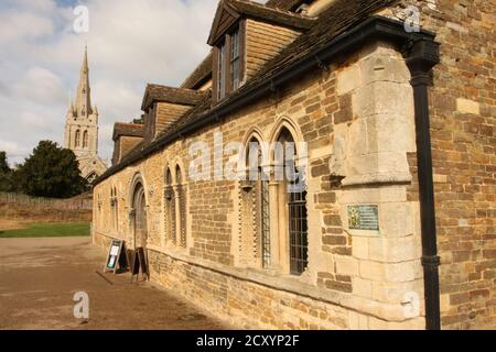 Great Hall of Oakham Castle (outside) with All Saints church in background Stock Photo