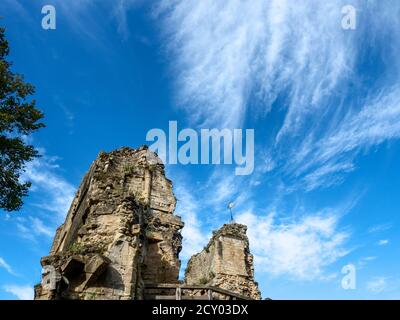 Wispy white clouds and blue sky above the Kings Tower at the Castle in Knaresborough North Yorkshire England Stock Photo