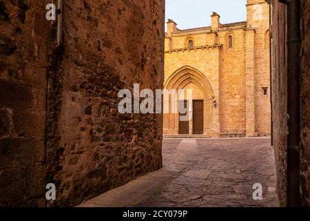 View of Santa Maria Cathedral, from Arco de la Estrella street, in the historic city center of Caceres, Spain.