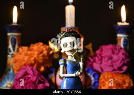 Closeup shot of plastic skulls female figurine for an offering of the day of the dead Stock Photo