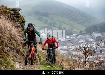 Two men ride mountain bikes on a trail at Glyncorrwg in the Afan Valley, in south Wales. Stock Photo