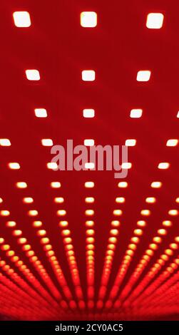 RGB LED screen panel texture. Close-up of a pixel LED screen with bokeh for wallpaper. Bright red abstract background perfect for any design Stock Photo