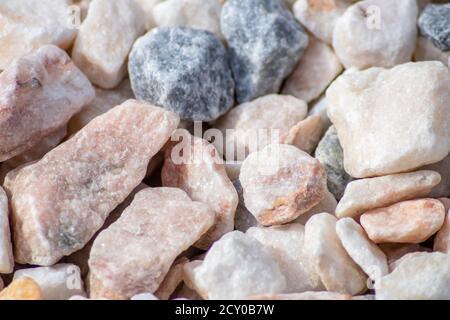 Raw rocks and minerals as natural stones background with crushed and rough material at a rough coast or rocky beach show nuggets and sandstones Stock Photo