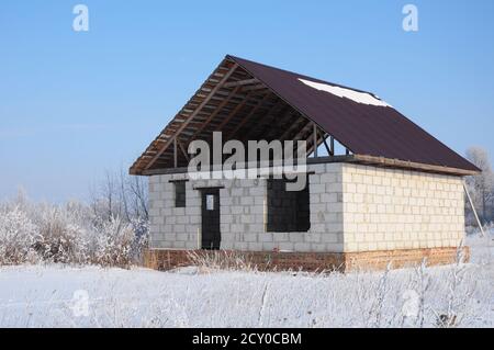 Building a house in the winter. Building a Home During Winter Stock Photo