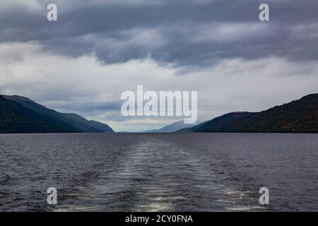 View of turbulent waters over lake with dark mountains in the backgrou Stock Photo