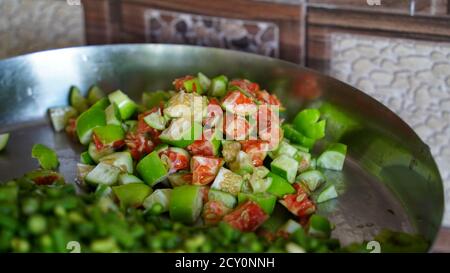 Chopped vegetables arranged on cutting board on the kitchen stand, side view Stock Photo