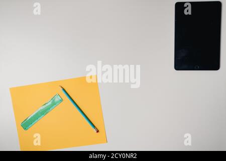 tablet and craft supplies on plain white background Stock Photo