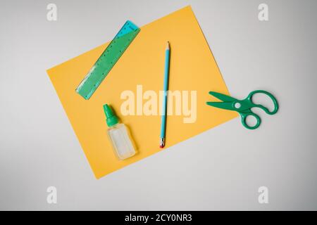 home school education supplies in green and yellow on white background Stock Photo