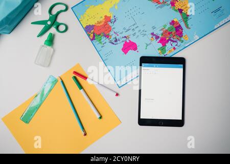Home school supplies on white background tablet and project materials Stock Photo