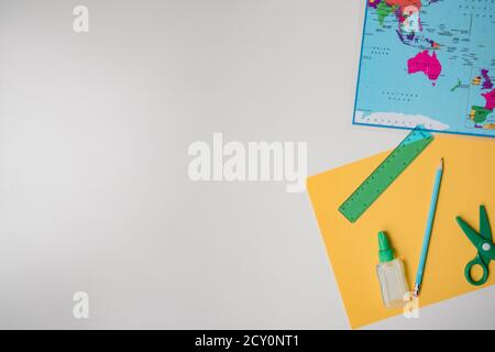 learning activity with map and scissors on plain white background Stock Photo