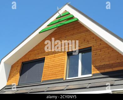 House Blinds Sun Protection Exterior. Windows in New Modern Passive House Facade Wooden Wall with Shutters Closed and Opened Outdoors. Stock Photo