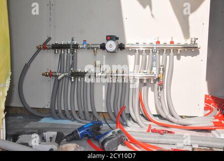Underfloor heating regulations. Floor Heating Systems Installation in New House Building. Underfloor heating. Stock Photo