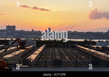 Subway trains outside in midtown Manhattan west side and view on New Jersey. Beautiful sunset Stock Photo