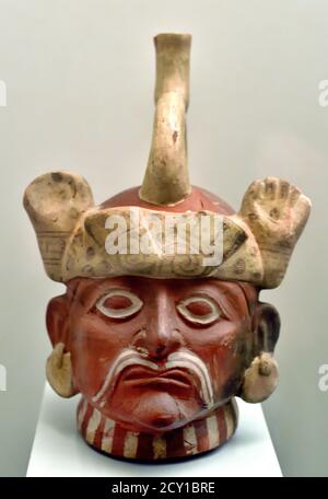 Great Lord as indicated by his headdress of feline claws, his large ear flaps and his face paint,  Moche or Mochica 100 AD - 700 AD. ceramics They lived in coastal valleys in Northern Peru. Like other Peruvian cultures farmers built canals to irrigate their crops, (warlike people and warriors) Stock Photo