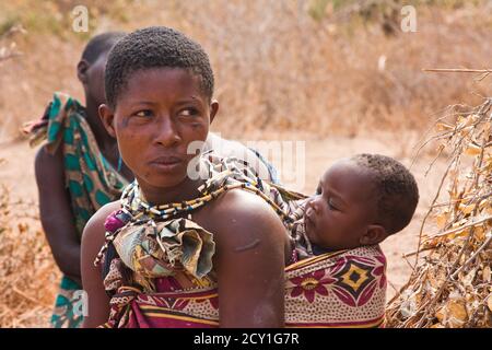 A woman and a baby  on her backTheת  Hadza, or Hadzabe - are an indigenous ethnic group in north-central Tanzania Stock Photo