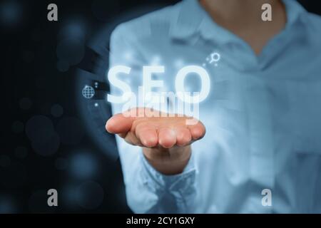 search engine optimization concept with the girl holds a digital display. Stock Photo