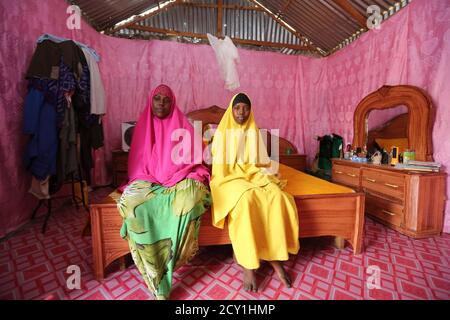 Saciido Sheik Yacquub, 34, poses for a picture with her daughter Faadumo Subeer Mohamed, 13, at their home in Hodan district IDP camp in Mogadishu February 11, 2014. Saciido, who runs a small business, wanted to be a business woman when she was a child. She studied until she was 20. She hopes that Faadumo will become a doctor. Faadumo will finish school in 2017 and hopes to be a doctor when she grows up. On March 8 activists around the globe celebrate International Women's Day, which dates back to the beginning of the 20th century and has been observed by the United Nations since 1975. The UN 