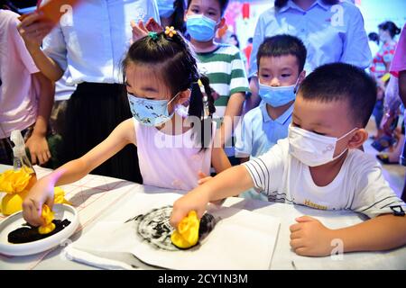 Haikou, China's Hainan Province. 1st Oct, 2020. Visitors experience rubbing during an event to celebrate the Mid-Autumn Festival in Hainan Museum in Haikou, capital of south China's Hainan Province, Oct. 1, 2020. Credit: Guo Cheng/Xinhua/Alamy Live News Stock Photo