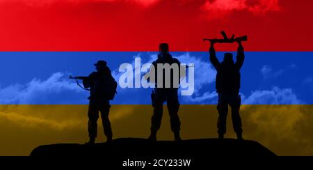 Flag of Armenia. Concept of the Conflict between Armenia and Azerbaijan. Military silhouettes fighting scene dark toned foggy background. Stock Photo
