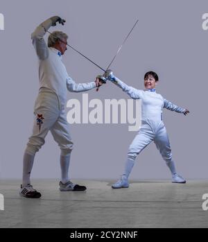 Two fencers show the En Garde opening pose in Oakland, Calif on Mar 20, 2011 Stock Photo