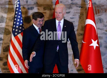 U.S. Vice President Joe Biden (R) and Turkey's Prime Minister Ahmet Davutoglu arrive at their meeting in Istanbul November 21, 2014. Turkey and the United States played down differences in the fight against Islamic State on Friday, but Prime Minister Ahmet Davutoglu made clear Ankara would keep pressing for a no-fly zone in Syria and President Bashar al-Assad's removal. REUTERS/Murad Sezer (TURKEY - Tags: POLITICS)