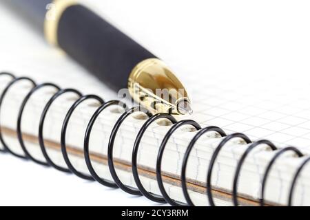 Automatic ballpoint pen and notepad isolated on white background. Stock Photo