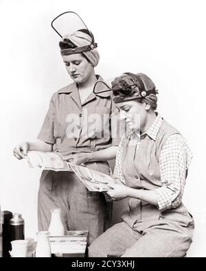 1940s ROSIE THE RIVETER TWO WOMEN WW2 DEFENSE INDUSTRY WORKERS IN COVERALLS AT LUNCH LOOKING AT UNITED STATES SAVINGS BONDS  - d1974 HAR001 HARS SECURITY YOUNG ADULT SAVINGS TEAMWORK LIFESTYLE SATISFACTION HISTORY FEMALES WW2 JOBS UNITED STATES HALF-LENGTH LADIES PERSONS INSPIRATION UNITED STATES OF AMERICA CARING CONFIDENCE B&W NORTH AMERICA FREEDOM NORTH AMERICAN SUCCESS SKILL OCCUPATION SKILLS HOME FRONT BONDS STRENGTH VICTORY STRATEGY COURAGE CHOICE WORLD WARS LABOR PRIDE WORLD WAR WORLD WAR TWO WORLD WAR II AT IN OPPORTUNITY EMPLOYMENT INVESTING OCCUPATIONS RIVETER ROSIE CONCEPTUAL Stock Photo