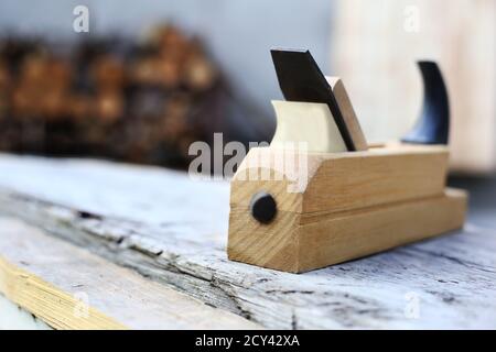 spokeshave, plane in carpentry workshop on wood. Close-up Stock Photo