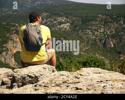 Hiker seen from the back looking at the mountain landscape Stock Photo