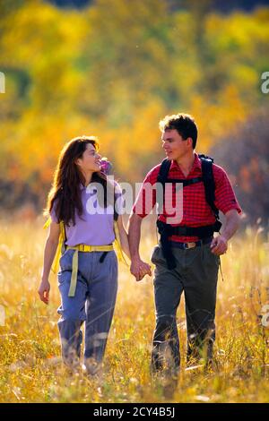 1990s BRUNETTE COUPLE HIKING IN TALL GRASS HOLDING HANDS WEARING BACKPACKS SMILING LOOKING AT ONE ANOTHER - kh10998 WAL004 HARS AUTUMN SPACE CLOTHING COUNTRY LOOK NOSTALGIC FALL PAIR ROMANCE LEAVES COLOR JEANS HIKING TALL OLD TIME NOSTALGIA OLD FASHION CONVERSATION 1 COUNTRYSIDE YOUNG ADULT TEAMWORK COTTON STROLLER ATHLETE JOY LIFESTYLE BELT FEMALES MARRIED RURAL SPOUSE HUSBANDS HEALTHINESS NATURE COPY SPACE FRIENDSHIP FULL-LENGTH LADIES PHYSICAL FITNESS MARRIAGE PERSONS CARING MALES ATHLETIC PLAID DENIM MEADOW PARTNER BRUNETTE FRESH HAPPINESS ADVENTURE DISCOVERY RECREATION FALL SEASON Stock Photo