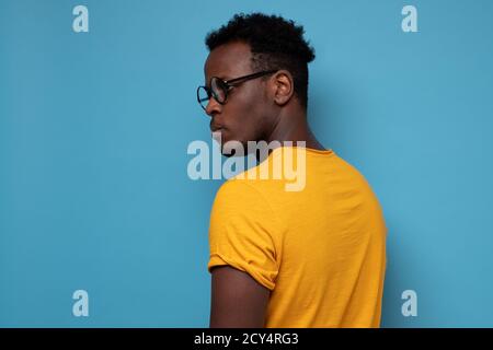 African man in glasses turning back. He is standing alone Stock Photo