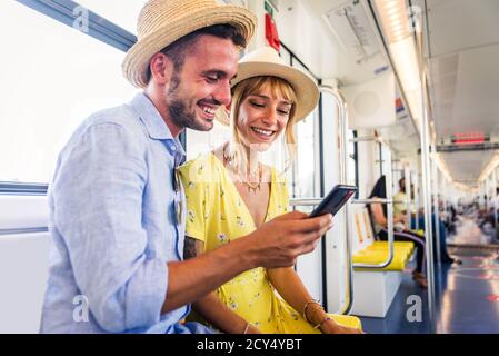 Beautiful couple driving on a subway wagon, concepts about lifestyle and trasportation Stock Photo