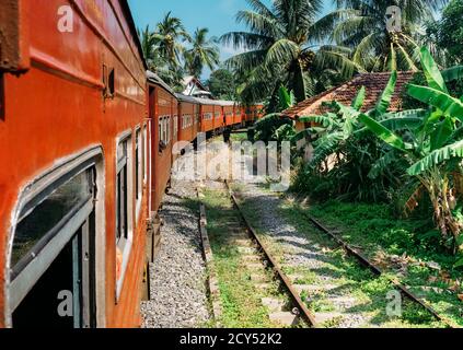 Scenery railway road from  Colombo to Matara. The train goes by jungles, local villages.. Sri Lanka, December 2017 Stock Photo