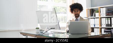 African American Business Man Using Computer In Office Stock Photo