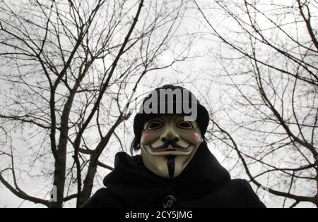 A protestor wearing Guy Fawkes masks participates in a demonstration against the Anti-Counterfeiting Trade Agreement (ACTA) in Berlin February 25, 2012. Protesters fear that ACTA, which aims to cut trademark theft and other online piracy, will curtail freedom of expression, curb their freedom to download movies and music for free and encourage Internet surveillance. REUTERS/Tobias Schwarz (GERMANY - Tags: POLITICS CIVIL UNREST)
