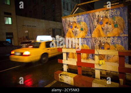 A taxi drives past posters advertising the 'End of the World' in New York December 21, 2012. Thousands of mystics, hippies and spiritual wanderers will descend on the ruins of Maya cities on Friday to celebrate a new cycle in the Maya calendar, ignoring fears in some quarters that it might instead herald the end of the world. The close of the 13th bak'tun - a period of some 400 years - in the 5,125-year-old Long Calendar of the Maya has raised fears among groups around the world that the end is nigh.  REUTERS/Andrew Kelly (UNITED STATES - Tags: SOCIETY ANNIVERSARY RELIGION)
