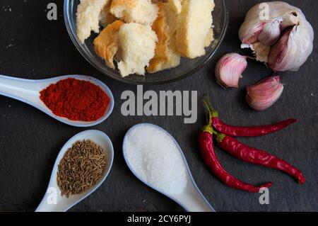 Flat lay of a table in which we have the dry ingredients of the typical red mojopicon sauce from the Canary Islands in Spain Stock Photo