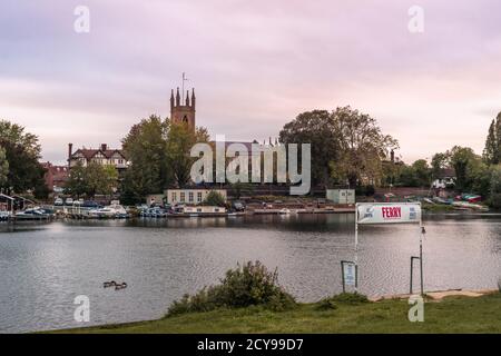 Sunset over the Thames river with Saint Mary's Parish Church in Hampton, West London, England, UK Stock Photo