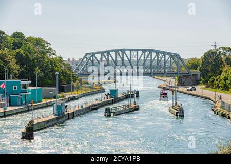 Image of a pleasure boat going through the locks at the Shinnecock Canal in Long Island, NY Stock Photo
