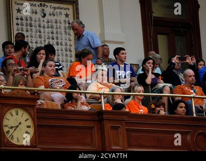 Abortion rights activists sit stoically after the HB2 bill restricting abortion rights passed in Austin, Texas July 9, 2013. The Texas House of Representatives approved a bill on Tuesday that would mandate sweeping abortion restrictions, including a ban on most abortions after 20 weeks of pregnancy and tougher standards for abortion clinics.    REUTERS/Mike Stone (UNITED STATES - Tags: POLITICS SOCIETY)
