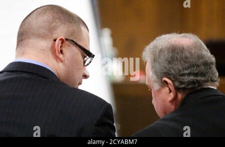 Former Marine Cpl. Eddie Ray Routh (L) speaks with his attorney court appointed defense attorney Tim Moore during his murder trial in Stephenville, Texas, February 11, 2015. Opening statements began in the trial of Routh, 27, charged with murdering Navy SEAL sniper Chris Kyle as well as Kyle's friend Chad Littlefield in February 2013 at a shooting range about 70 miles (110 km) southwest of Fort Worth.  REUTERS/Tom Fox/The Dallas Morning News/Pool via Reuters  (UNITED STATES - Tags: CRIME LAW MILITARY)