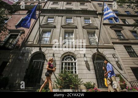 The flags of the European Union and Greece flutter as people walk in front of the Greece consulate in New York June 30, 2015. REUTERS/Eduardo Munoz