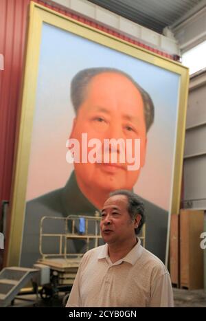 Ge Xiaoguang speaks in front of a giant portrait of China's late Chairman Mao Zedong during a interview with Reuters in his working studio located between the Tiananmen Square and the Forbidden City in Beijing June 29, 2011. Reclusive Chinese painter Ge's art has gazed over one of the world's most famous city squares for decades. For 30 years, he has painted the portraits of former paramount leader Mao Zedong that look across Beijing's Tiananmen Square. The giant oil paintings of the 'Great Helmsman' have kept watch from the Gate of Heavenly Peace since the Communist Party won the civil war an