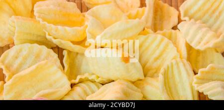 Crispy potato chips in a wicker basket Stock Photo