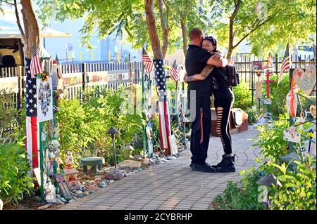 Las Vegas, Nevada, USA. 1st Oct, 2020. A couple embraces while visiting the Las Vegas Healing Garden on October 1, 2020, in Las Vegas, Nevada. A gunman opened fire on October 1, 2017 from the 32nd floor of Mandalay Bay Resort and Casino on the Route 91 Harvest country music festival in Las Vegas killing 58 people and injuring more than 800 in the deadliest mass shooting event in U.S. history. Credit: David Becker/ZUMA Wire/Alamy Live News Stock Photo