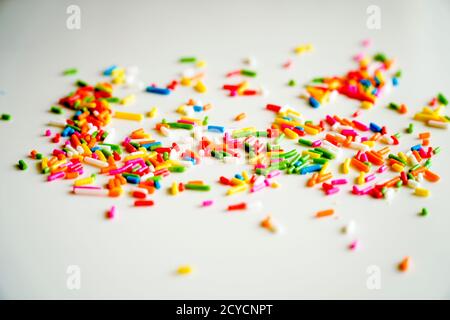 Selective focus colorful sugar sprinkle dots for decoration topping cake and ice cream on the table. Stock Photo