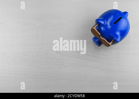 blue piggybank on a wooden table, top view Stock Photo